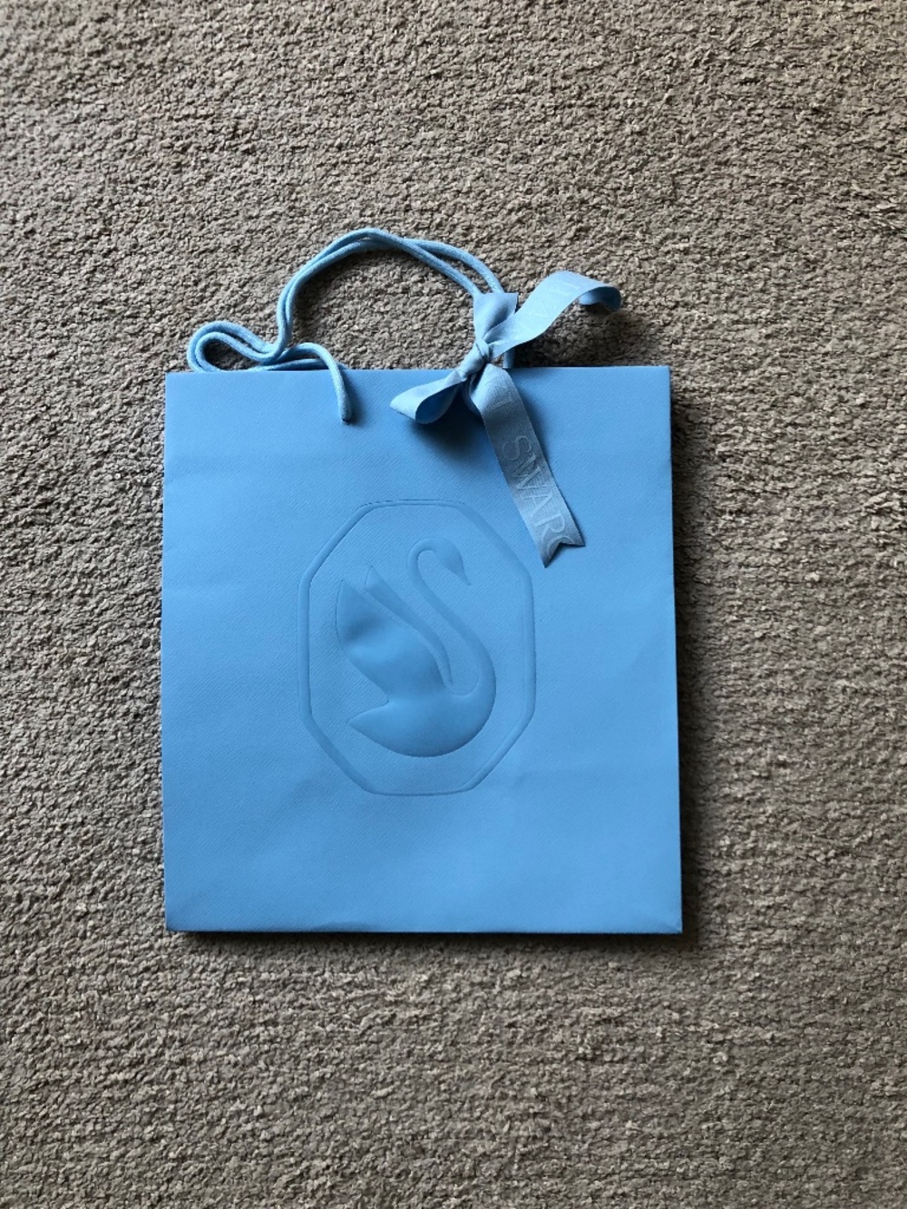 Swarovski paper shopping bag with ribbon.